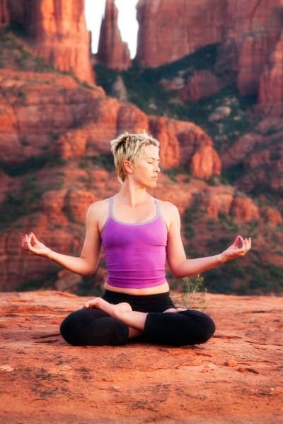 Resident sitting on rock meditating at Sterling Point in Phoenix, Arizona