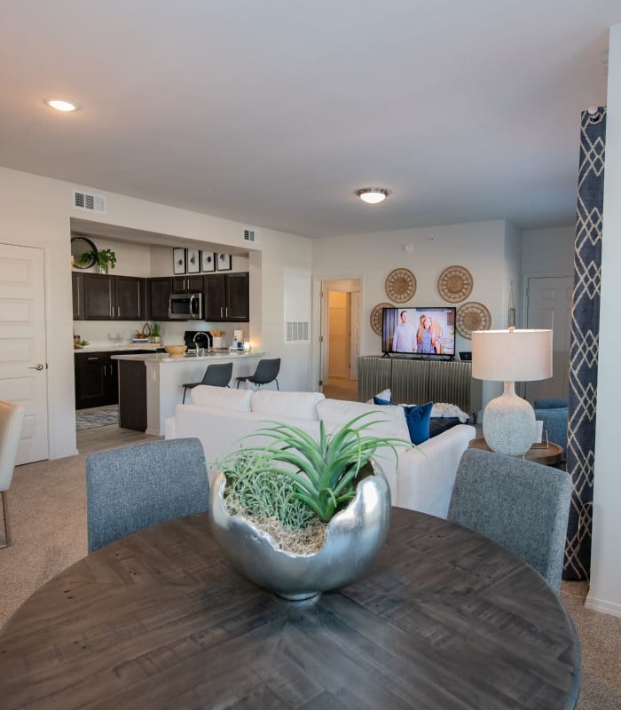 Carpeted living room and dining area at Center 301 Apartments in Belton, Missouri