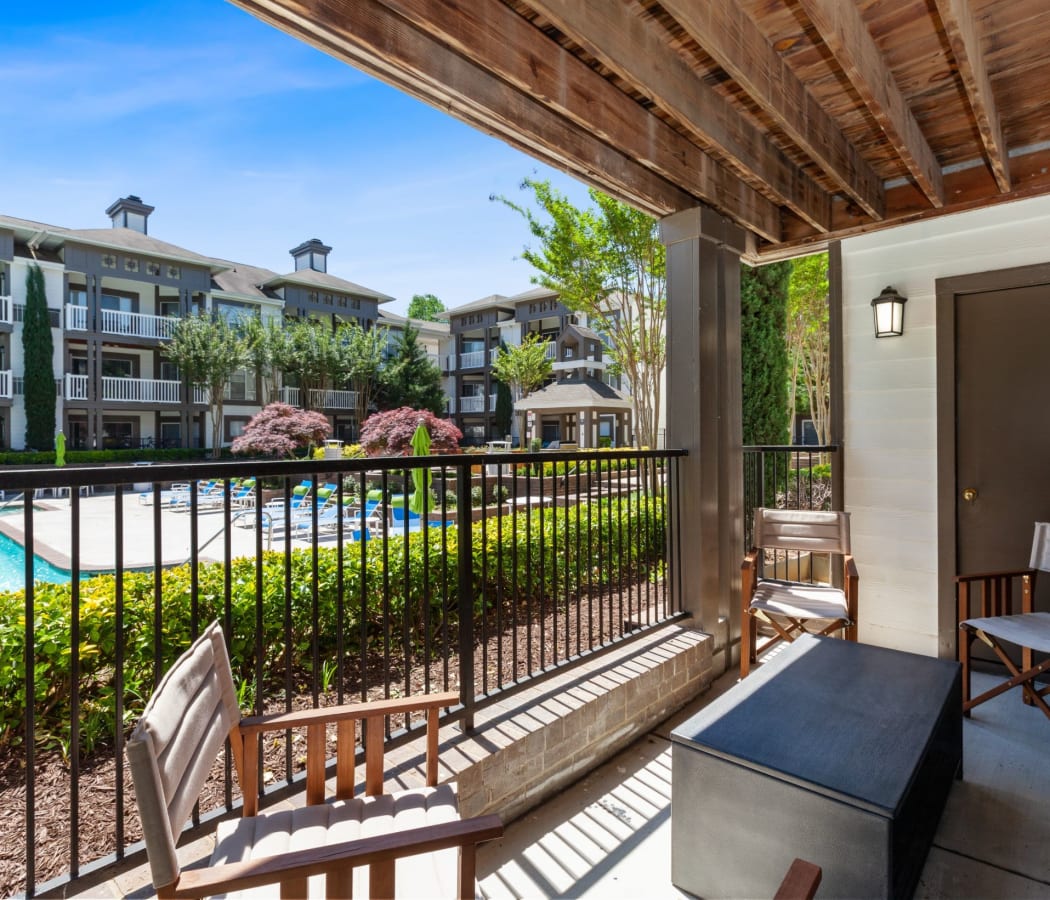 View of the sparkling swimming pool from the private patio at 45Eighty Dunwoody Apartment Homes in Dunwoody, Georgia