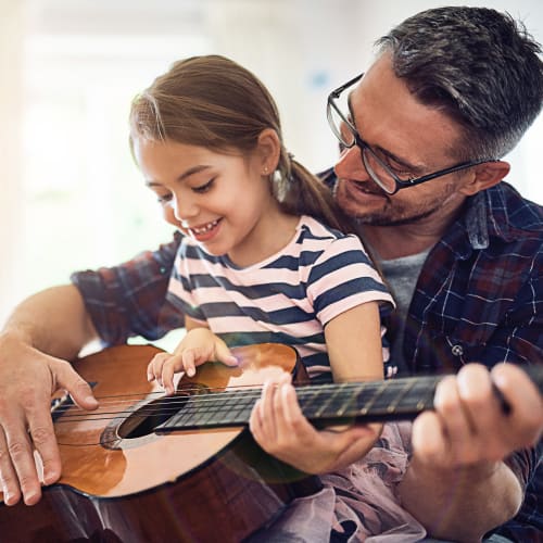 Resident with his daughter playing guitar at Holly Square in Imperial Beach, California