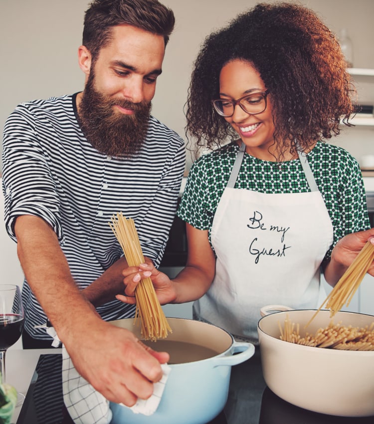 Resident couple cooking up a fantastic meal in their modern kitchen at Haven New Providence in New Providence, New Jersey