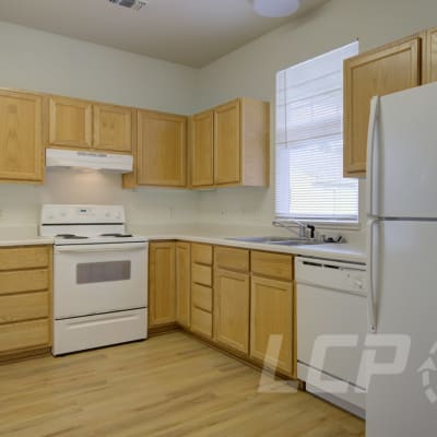 Wood cabinets and appliances in a kitchen at Beachwood South in Joint Base Lewis McChord, Washington