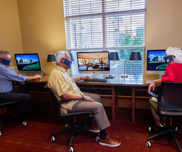 Residents at All Seasons Birmingham enjoy time on the computer in Birmingham, Michigan