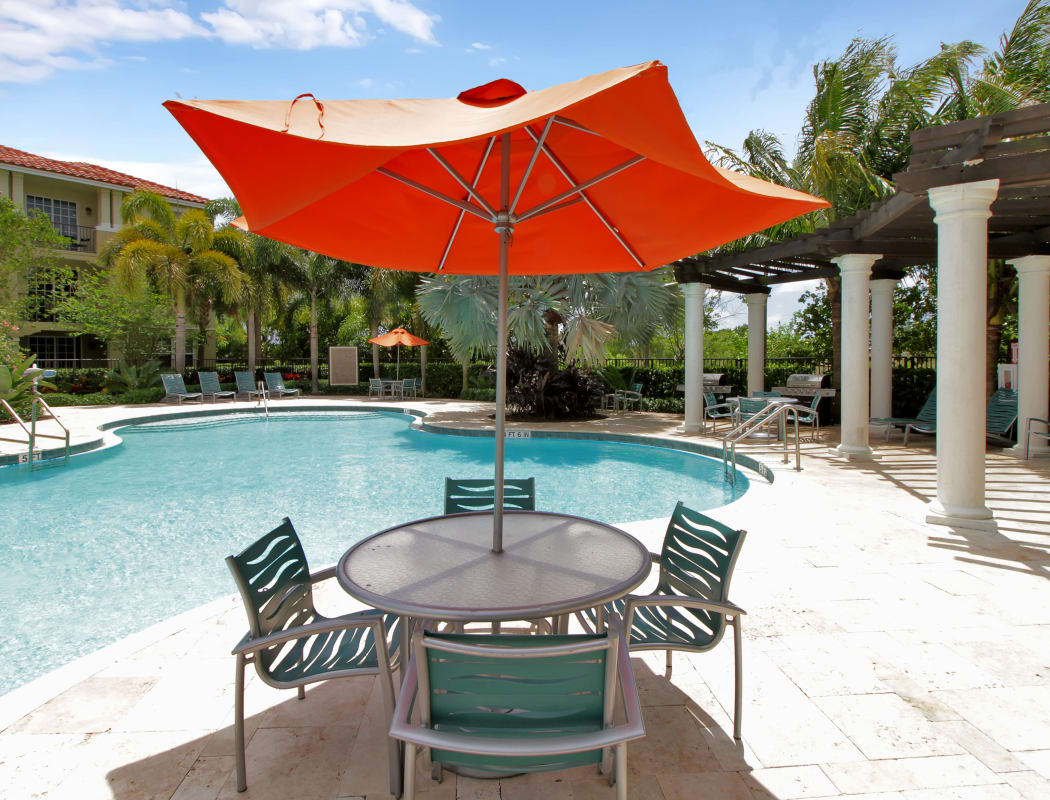 Shaded seating near the pool and pergola at IMT Miramar in Miramar, FL