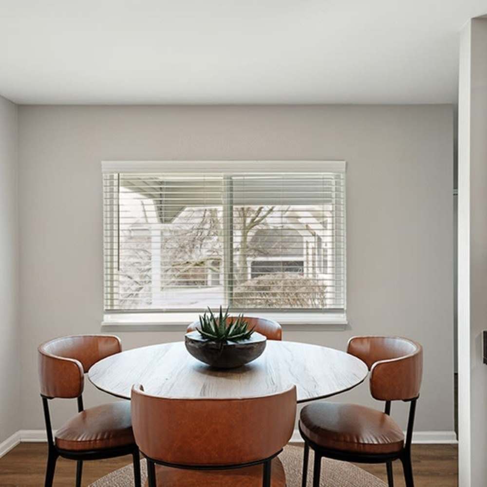 Bright dining area with round table at 83 West Townhomes in West Bloomfield Township, Michigan