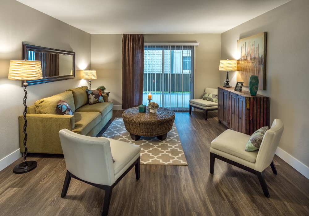Modern living room with wooden flooring and carpeting at Harbor Cove Apartments in Foster City, California,