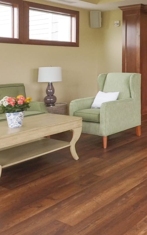 Seating area with upholstered chairs and coffee table at The Pillars of Mankato in Mankato, Minnesota