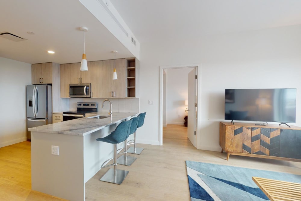 An open kitchen with an island at 55 Brighton at Packard Crossing in Boston, Massachusetts