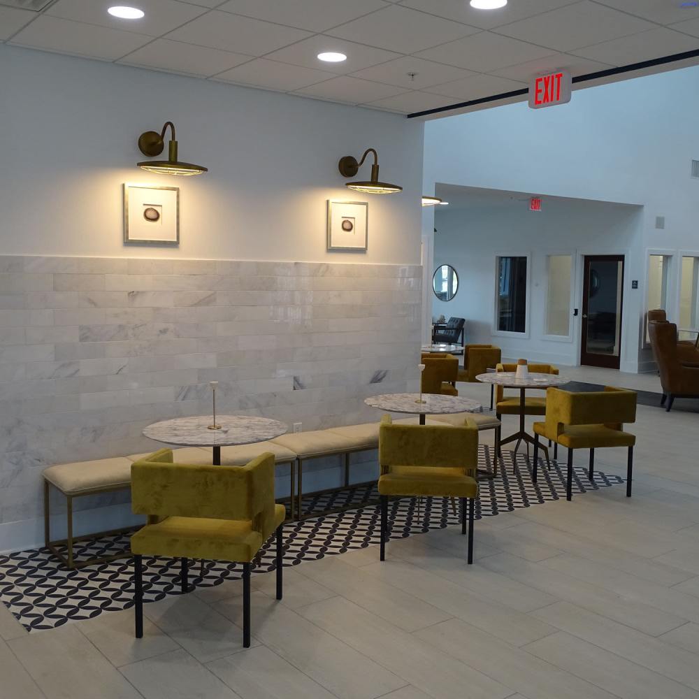 Chic lounge with modern seating and lighting at The Apartments At Kelton Station in Williamsburg, Virginia