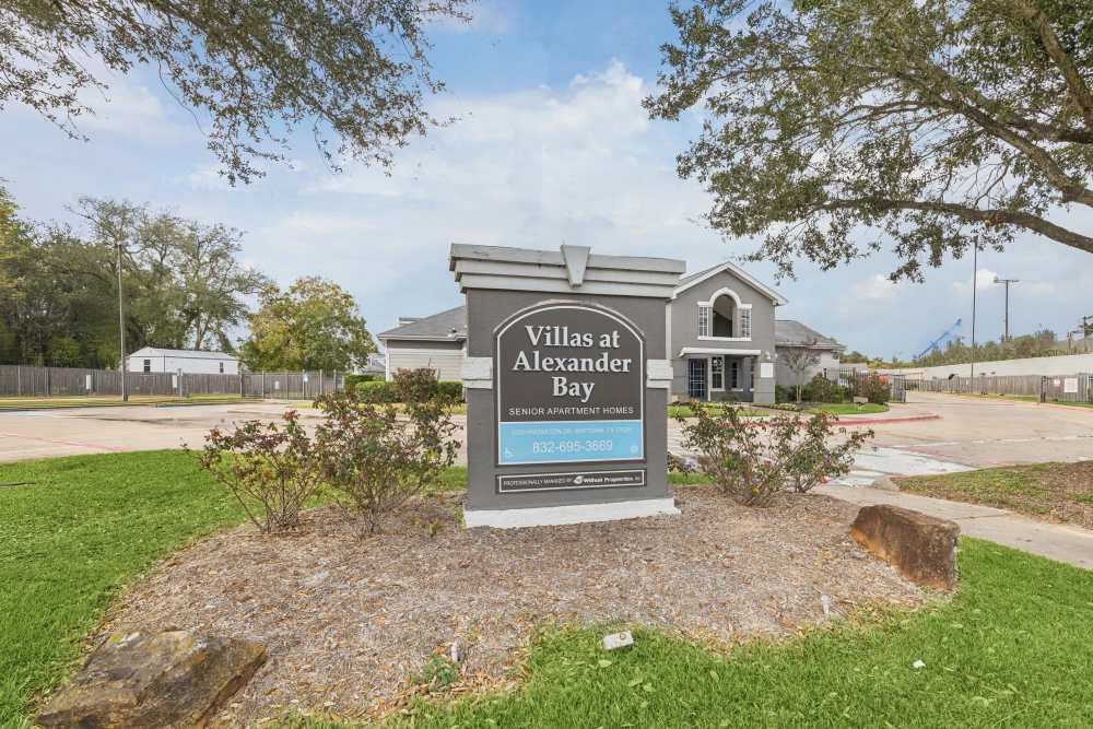 Villas at Alexander Bay sign with landscaped entrance at Villas At Alexander Bay in Baytown, Texas
