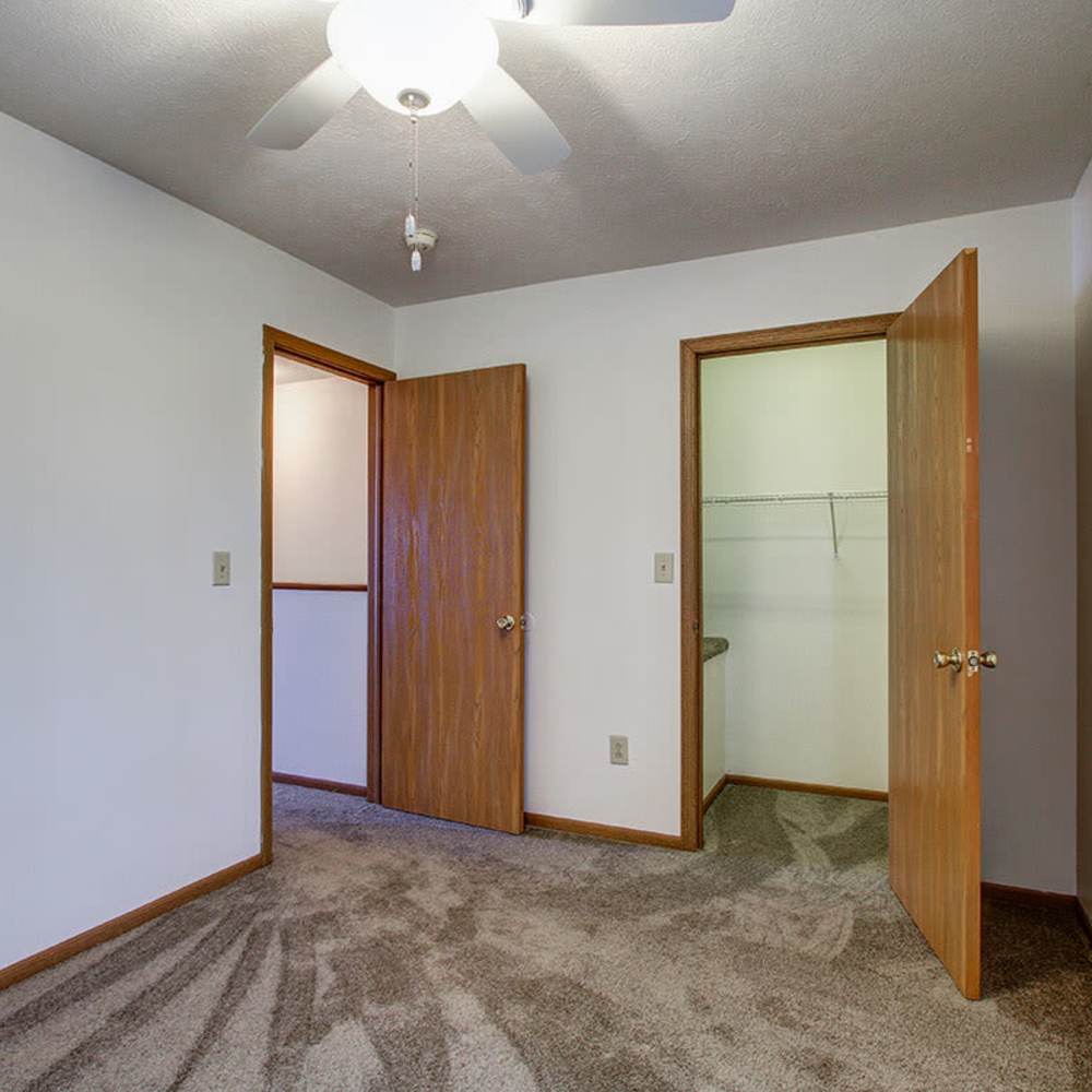 Carpeted room with two open doors at Wellington Place in Ottawa, Ohio