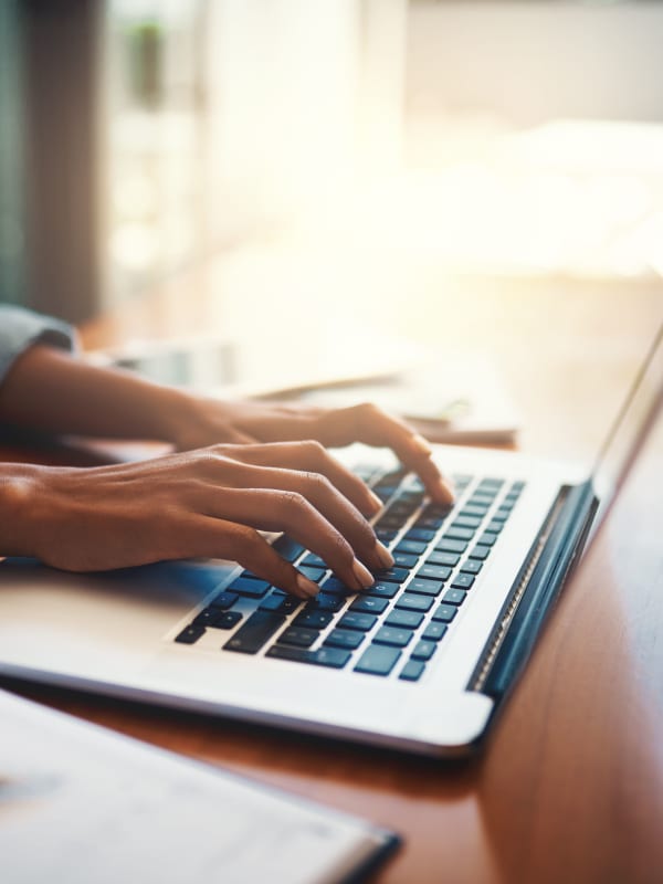 Resident typing on their computer at The Aeronaut in Weymouth, Massachusetts
