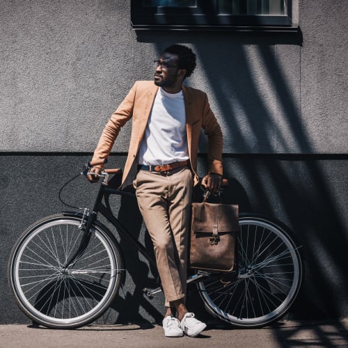 Resident biking to work from his home at 21 West Street in New York, New York