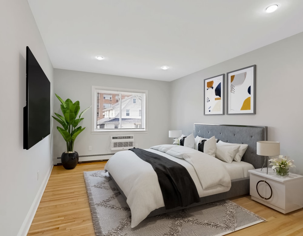 Master bedroom with hardwood floors at Grove Gardens in Freeport, New York