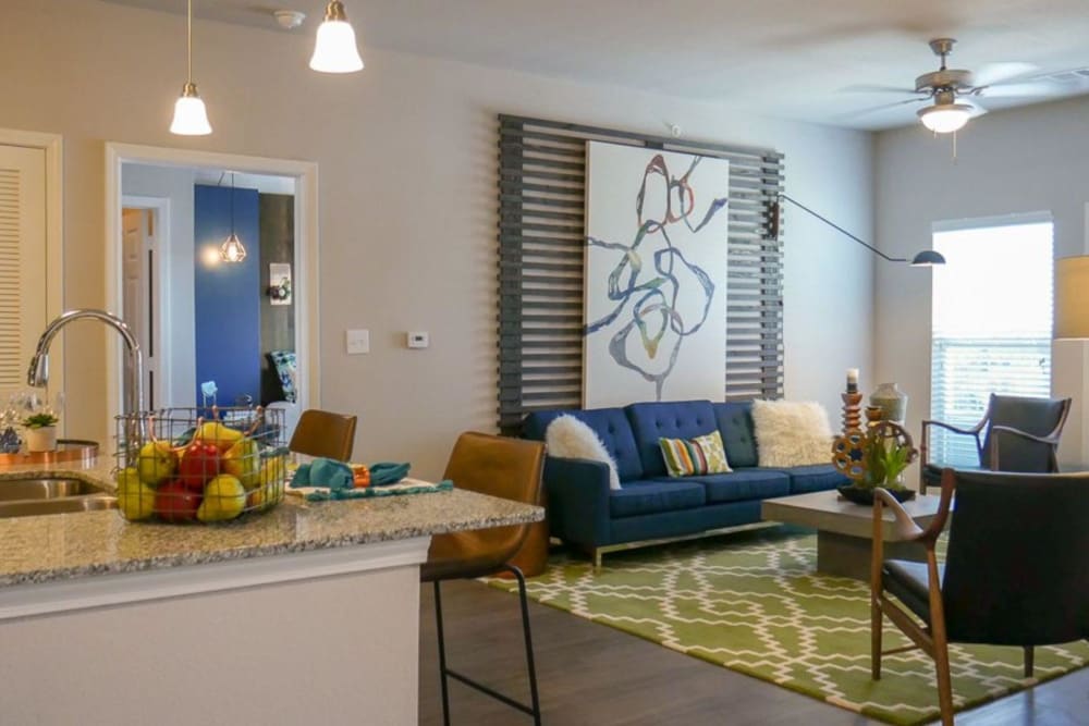 Open concept living room and kitchen at Biltmore at the Park in Pflugerville, Texas
