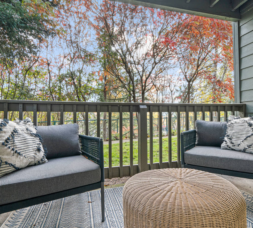 Large outdoor balcony looking out to the trees and grass on the grounds at Timbers at Tualatin in Tualatin, Oregon