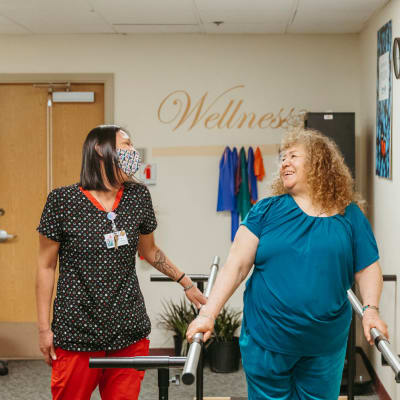 Certified nurse working with a resident on the treadmill at Cascade Park Vista Assisted Living in Tacoma, Washington