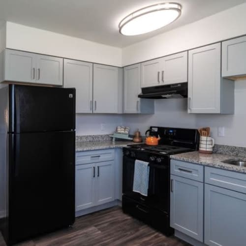 Apartment kitchen with black appliances at Amber Grove Apartments in Marietta, Georgia