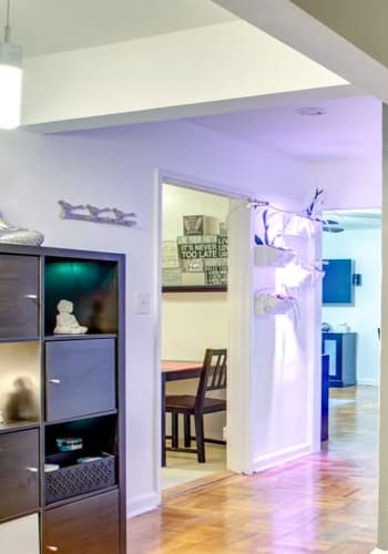 Well lit and wide hallways with hardwood floors at Linden Arms in Elizabeth, New Jersey