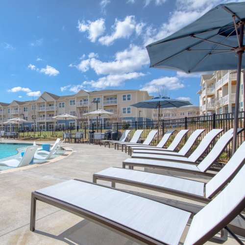 Resort-style pool with lounge chairs at The Mason in Augusta, Georgia