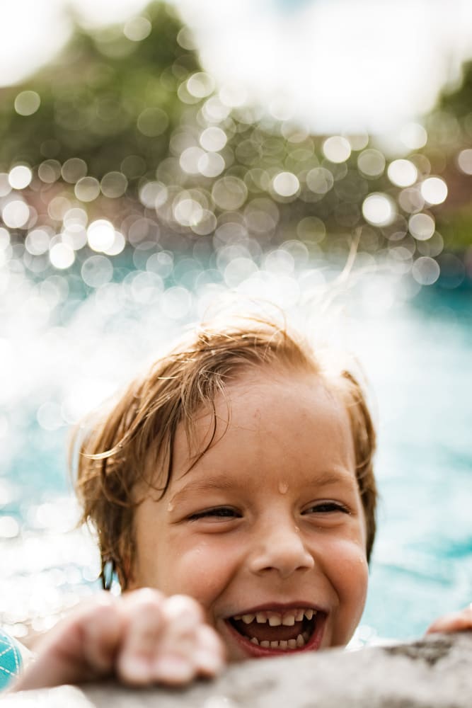 Young resident cooling off in the swimming pool at The Cascades Townhomes and Apartments in Pittsburgh, Pennsylvania