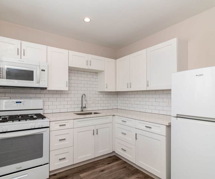 Kitchen with white appliances at Iwood I in Inglewood, California 
