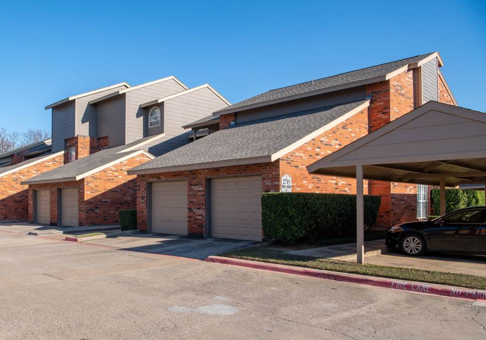 Exterior shot of apartments with covered parking at Copper Chase in Arlington, Texas