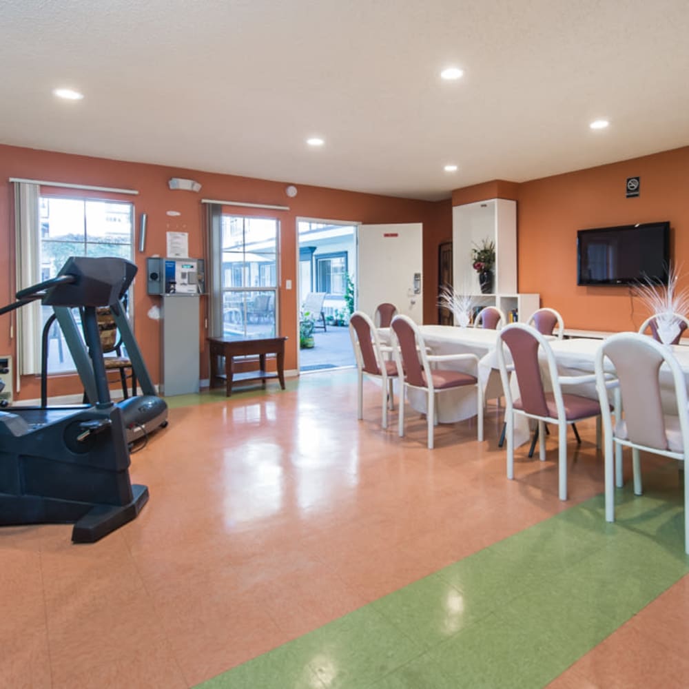 Community dining area with flat screen television at Tarzana Courtyard in Tarzana, California