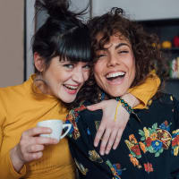 Best friends sharing a laugh at Bridgeview Apartments in San Diego, California