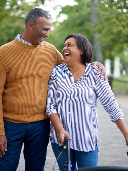 Resident walking with family member at Monark Grove Clarkston in Clarkston, Michigan