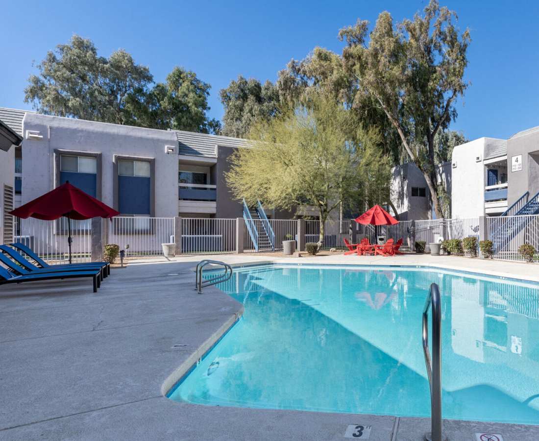Large swimming pool with lounge chairs at 544 Southern Apartments in Mesa, Arizona
