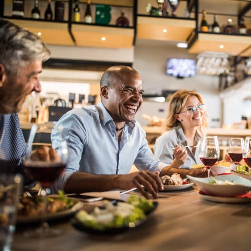 Residents having meal in restaurant near at Covenant Trace in Newport News, Virginia