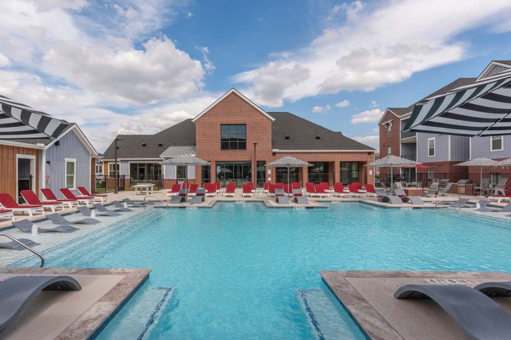New resort style pool with lounge chairs at The Landing College Station