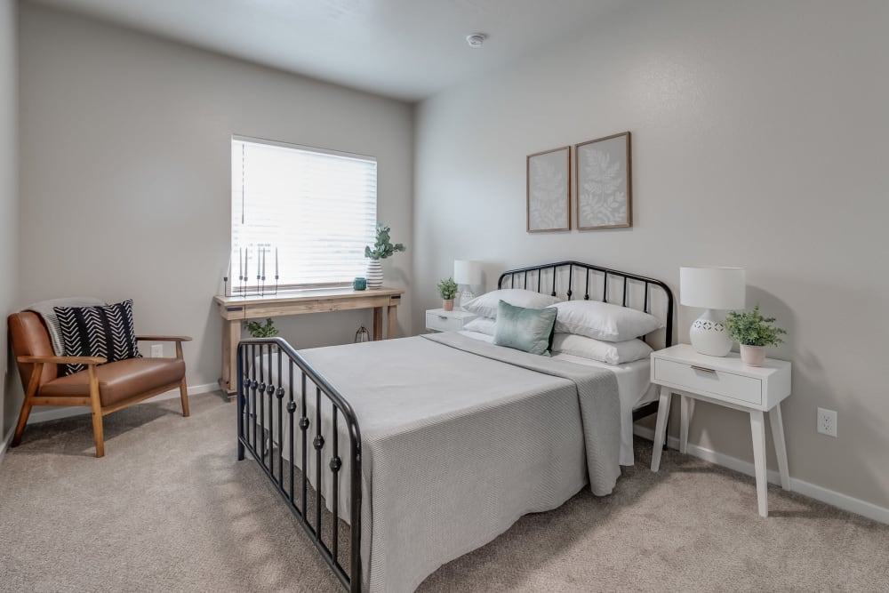 Model bedroom with plush carpeting at Olympus at Ten Mile in Meridian, Idaho