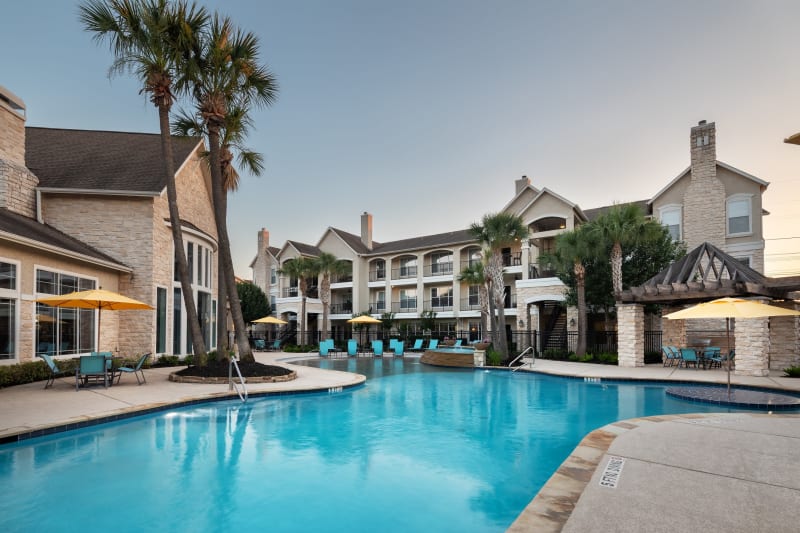 Resort style pool with lounge chairs at The Retreat at Cinco Ranch in Katy, Texas