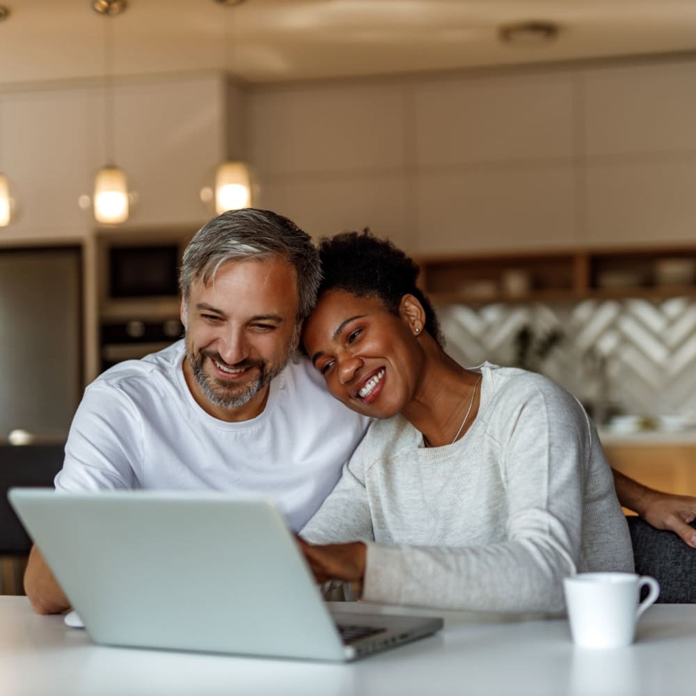 A couple browse the web in their apartment at LaCabreah, Brownsburg, Indiana