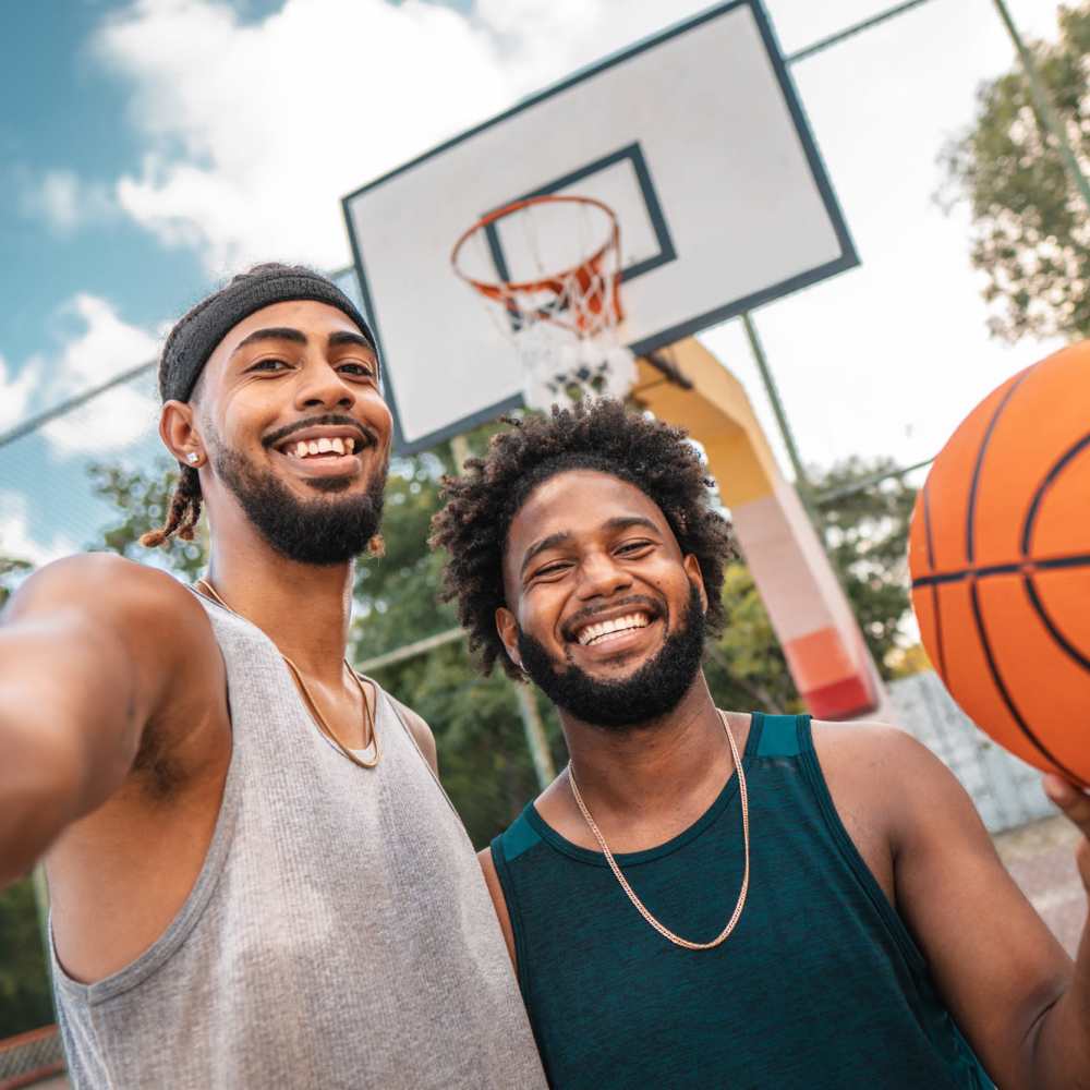 Luxury smiling men posing with a basketball at Commonwealth Landing Lofts in Fall River, Massachusetts