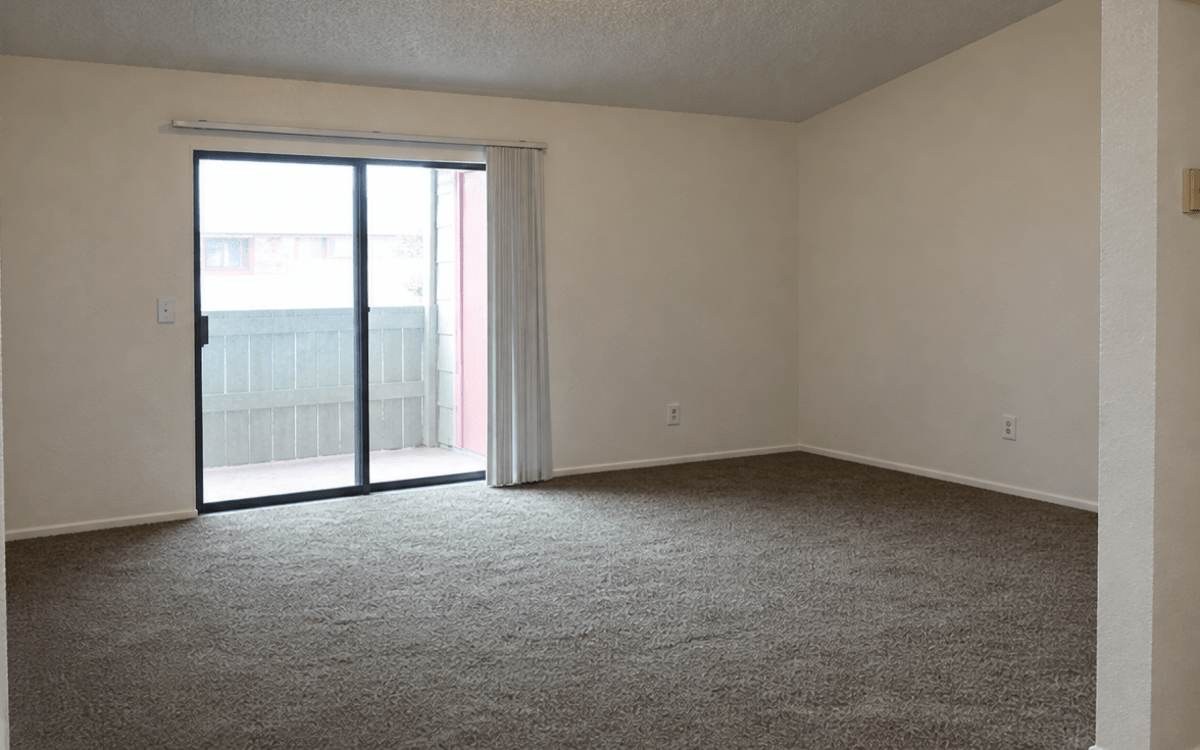 Open living area with sliding glass doors at Pleasant Run Apartments in Lancaster, Texas