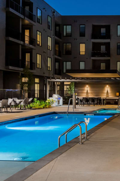 Luxury swimming pool light up at night at West 38 in Wheat Ridge, Colorado
