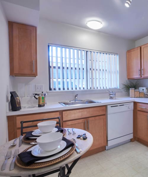 Eat-in kitchen with a dishwasher and stainless-steel sink at Muirwood in Farmington Hills, Michigan