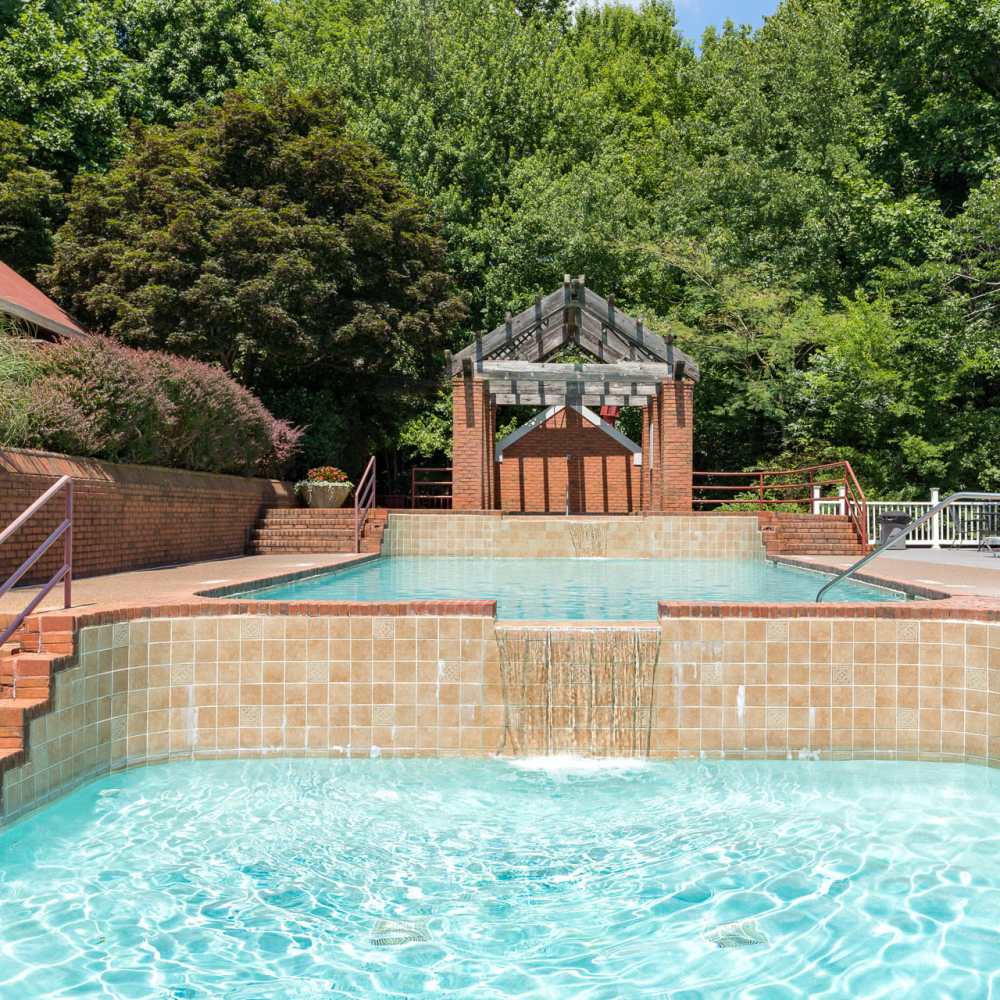 A swimming pool with a covered sitting area at Park Canyon in Dalton, Georgia