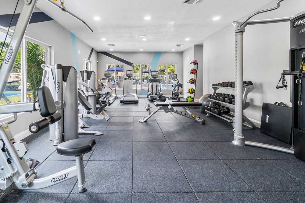 Community gym with weight machines at Boynton Place Apartments in Boynton Beach, Florida