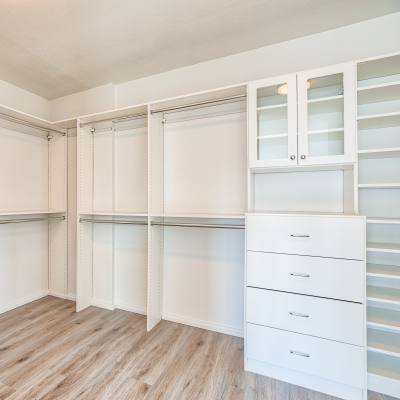 White cabinets and drawers neatly arranged in a walk-in closet at Panorama Apartments in Seattle, Washington