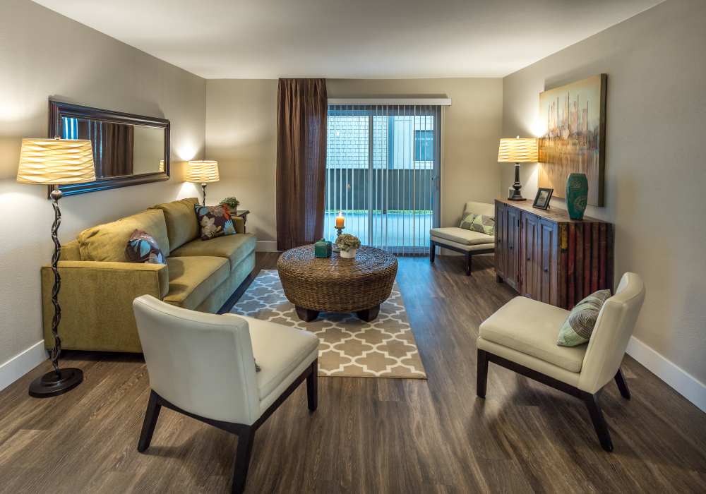 Stylish living room with large sofa and coffee-table at Harbor Cove Apartments in Foster City, California
