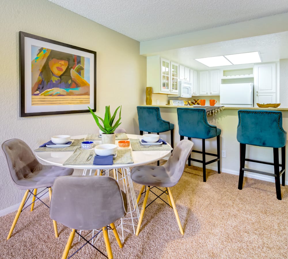 Dining area next to the kitchen's breakfast bar in a model home at Sofi Irvine in Irvine, California