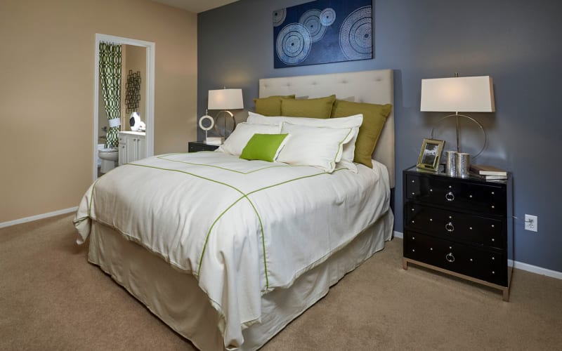 Spacious master bedroom with plush carpeting at Legend Oaks Apartments in Aurora, Colorado