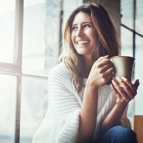 A resident holding her cup at Wire Mountain III in Oceanside, California