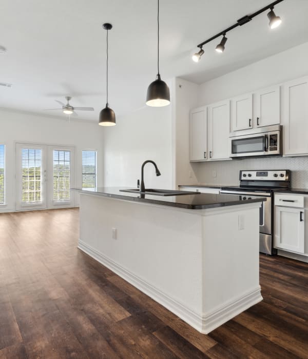 Model living room and kitchen at West Lake Vistas in Austin, Texas