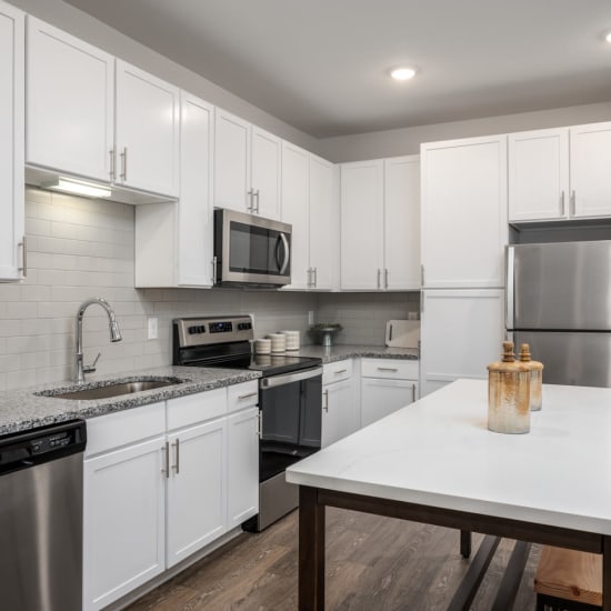 Stainless-steel appliances and white cabinets in an apartment kitchen at Novo Westlake in Jacksonville, Florida