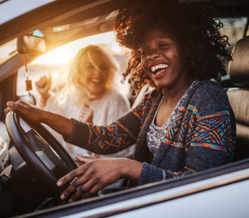 Resident laughing with friend while driving near The Terrace in Tarzana, California